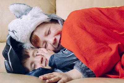 Boys sleeping on sofa