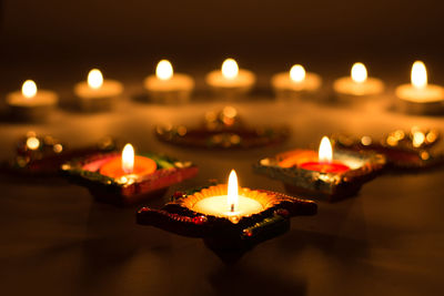 Close-up of lit diyas during diwali