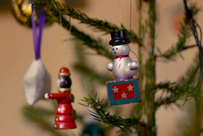 Close-up of christmas decorations hanging on tree