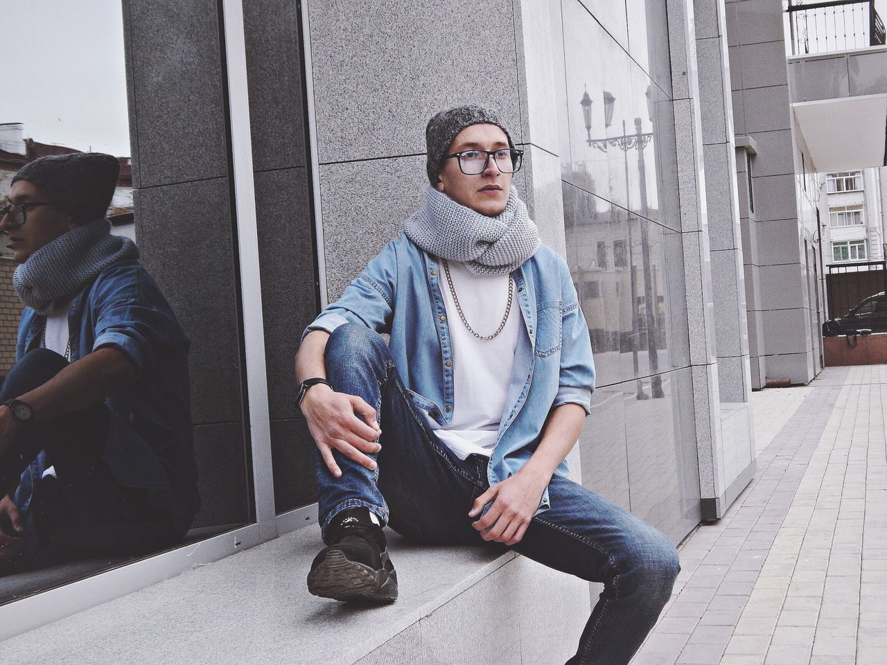 YOUNG WOMAN SITTING ON A CITY