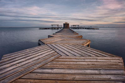 Pier over sea against sky