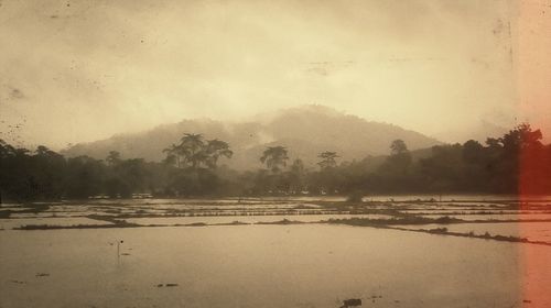 Scenic view of lake against sky during winter