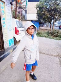 Portrait of boy standing in city