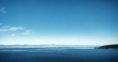 Scenic view of sea against blue sky