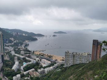 High angle view of buildings by sea against sky