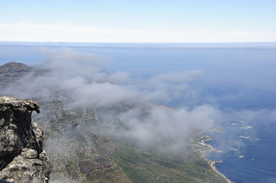 Aerial view of sea and mountain against sky
