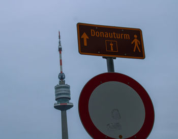 Low angle view of road sign against sky