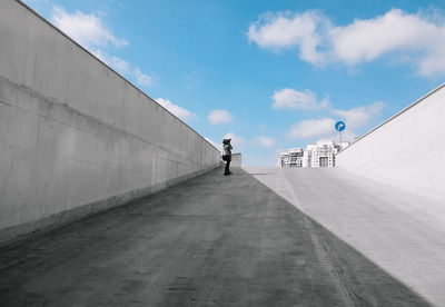 Woman on street against sky