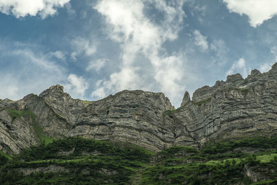 Low angle view of rock formation against sky