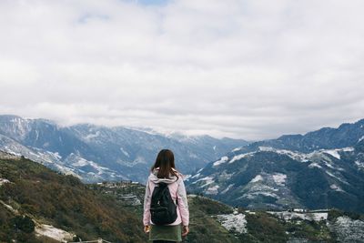 Scenic view of mountains against cloudy sky