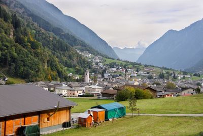 Houses by mountains against sky