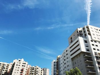 Low angle view of buildings against blue sky