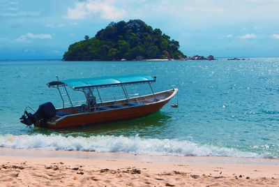 Boat on beach against sky