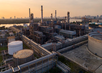 High angle view of factory against sky during sunset