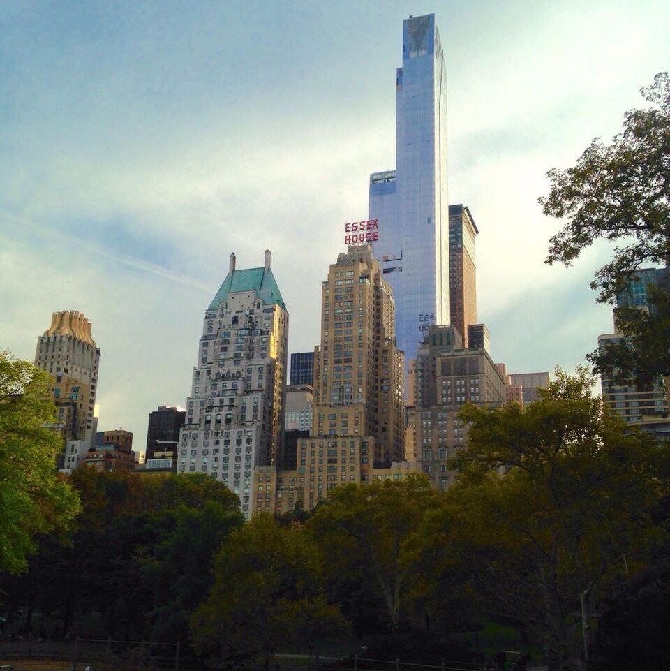 building exterior, architecture, skyscraper, built structure, city, modern, tall - high, office building, tower, tree, sky, low angle view, financial district, growth, building, urban skyline, cityscape, capital cities, tall, cloud - sky