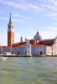 View of buildings at waterfront against sky