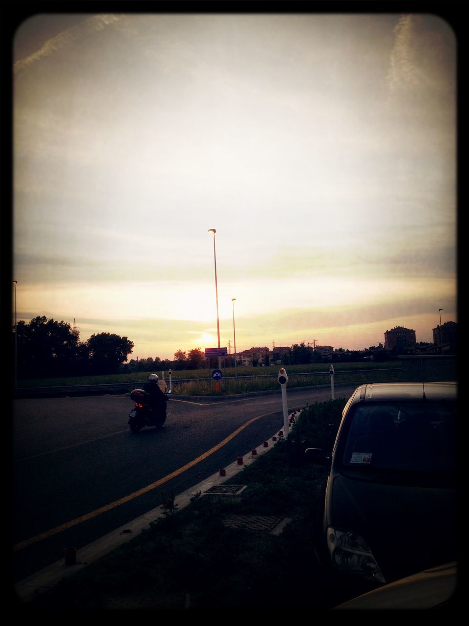 transportation, car, transfer print, land vehicle, sunset, road, mode of transport, auto post production filter, sky, street, cloud - sky, on the move, road marking, orange color, silhouette, traffic, travel, outdoors, cloud, the way forward