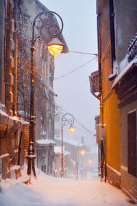 Illuminated street lights hanging in snow