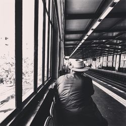 Rear view of man on train at railroad station platform