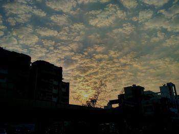 Low angle view of silhouette cityscape against sky during sunset