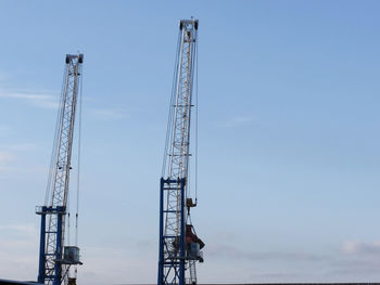 Low angle view of crane against sky