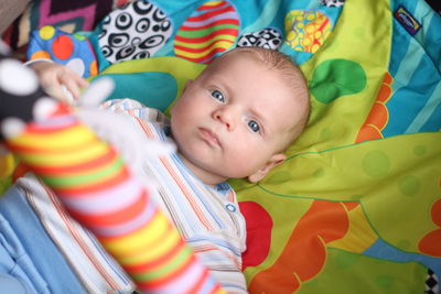 Portrait of cute boy lying on bed