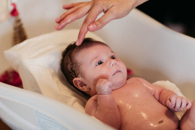 High angle view of cute baby girl taking a bath