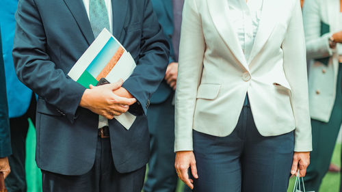 Midsection of business people walking on footpath