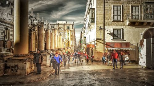 People in front of building against sky