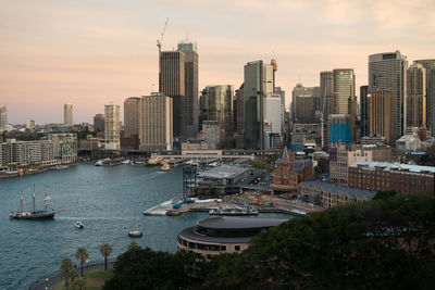 Aerial view of buildings in city against sky during sunset