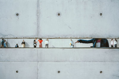 Group of people working on wall