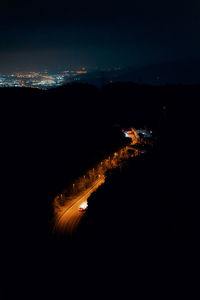 High angle view of illuminated road in forest