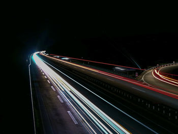 High angle view of light trails on highway at night