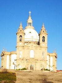 Low angle view of building against clear blue sky