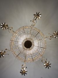 Low angle view of illuminated chandelier against sky
