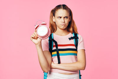 Portrait of woman with pink hair against gray background