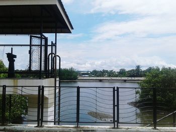 Built structure against sky with water in foreground