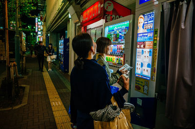 People sitting in illuminated room