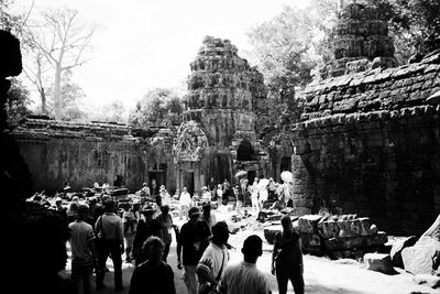 People at temple against sky