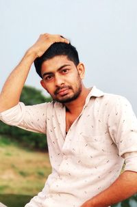 Portrait of young man standing outdoors