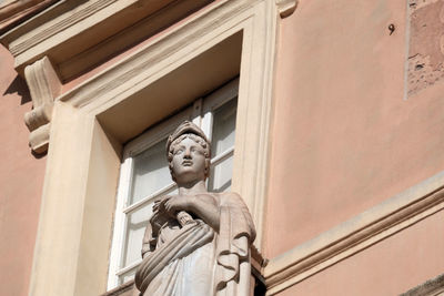 Low angle view of statue against building