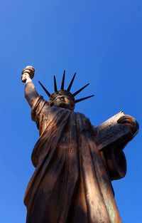 Low angle view of statue against clear blue sky