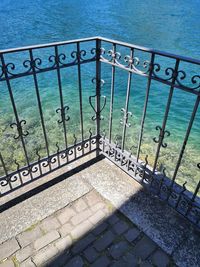 High angle view of closed gate by sea