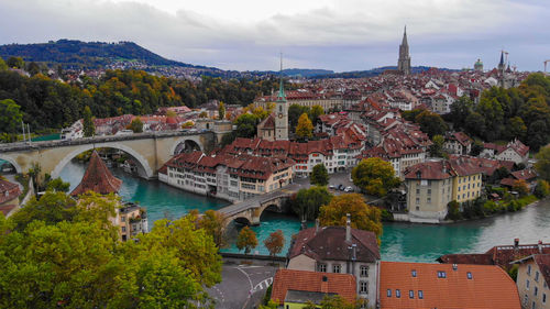 High angle view of bridge over river amidst buildings in city