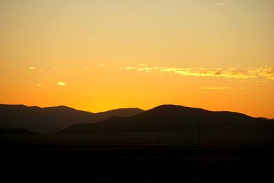 Scenic view of silhouette mountains against sky during sunset