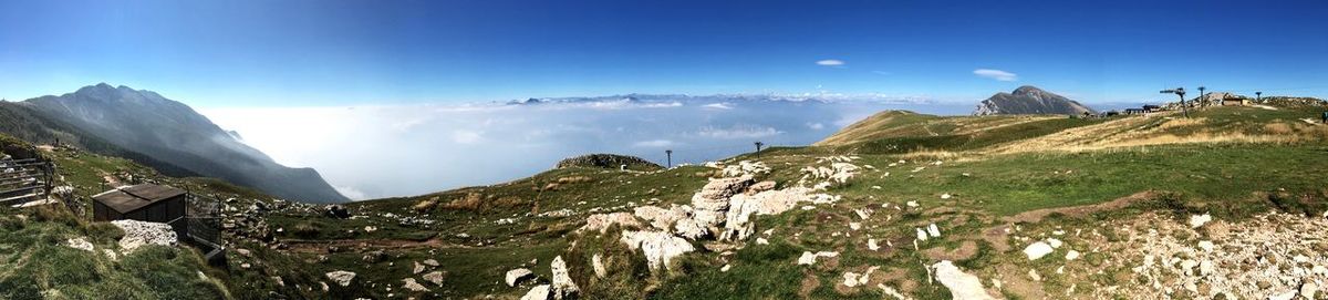 Panoramic view of mountains against blue sky