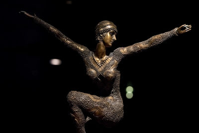 Close-up of statue against black background