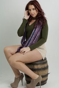 Young woman sitting against white background