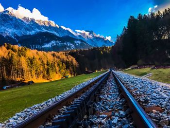 High angle view of railroad tracks by mountain against sky