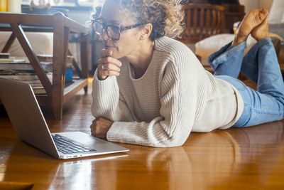 Young woman using laptop at table